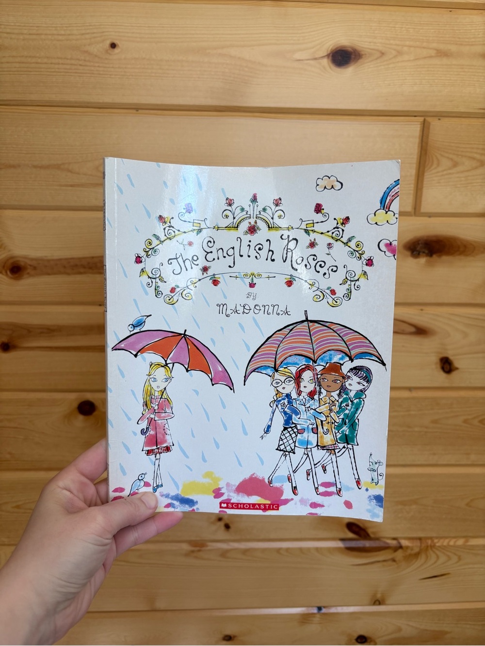 Scholastic White Cover Paperback with Colorful Umbrellas Illustration